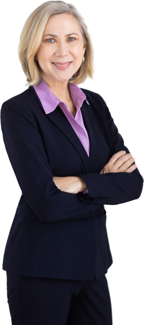 Lisa A. Welton, a smiling woman with short blonde hair wearing a suit and standing with arms crossed